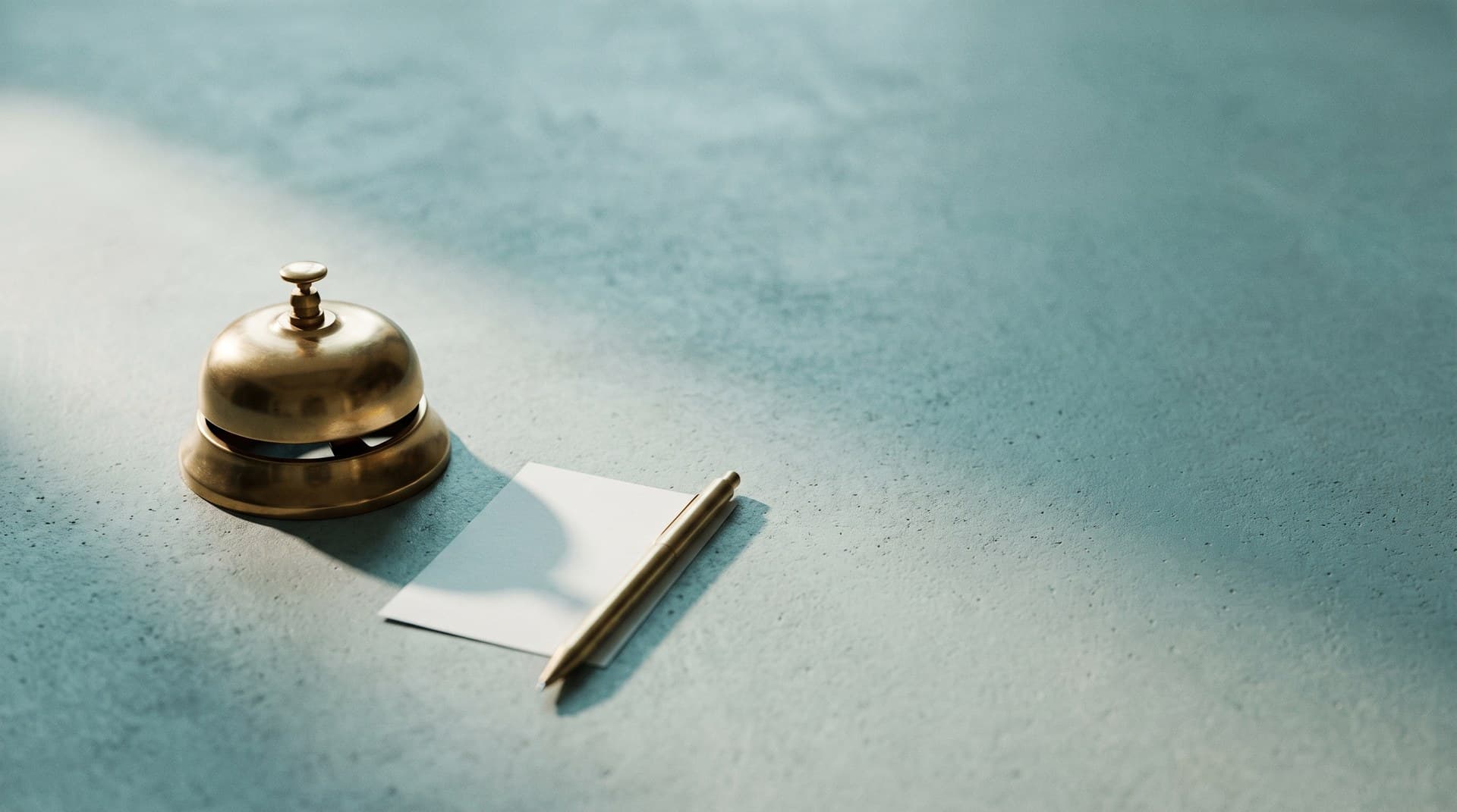 A brass service bell beside a blank paper request slip on a concrete surface, illustrating an MCP server asking a human through elicitation instead of borrowing the client's model